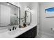 Bathroom with dual sinks, modern fixtures, and a walk-in shower with glass enclosure at 18026 Reynolds Pkwy, Orlando, FL 32833