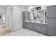 Spacious bathroom with double vanity, storage, and luxurious marble-style tile flooring at 18026 Reynolds Pkwy, Orlando, FL 32833
