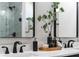 Close up of a modern bathroom vanity with black hardware, black faucets, and decor at 18026 Reynolds Pkwy, Orlando, FL 32833
