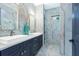Modern bathroom featuring double sinks, marble-look tile, and a glass-enclosed shower stall at 18026 Reynolds Pkwy, Orlando, FL 32833