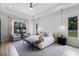 Bright bedroom featuring tray ceilings, pendant lighting, and furniture seating area at 18026 Reynolds Pkwy, Orlando, FL 32833