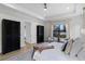 Primary bedroom with a seating area, black armoires, and bright outdoor light at 18026 Reynolds Pkwy, Orlando, FL 32833