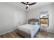 Cozy bedroom with a tufted headboard, neutral decor, and wood-look flooring at 18026 Reynolds Pkwy, Orlando, FL 32833