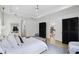 Bright primary bedroom with black armoires, grey rug, and access to en-suite bathroom at 18026 Reynolds Pkwy, Orlando, FL 32833