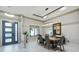 Elegant dining room with modern light fixture, sleek table setting, and large window offering natural light at 18026 Reynolds Pkwy, Orlando, FL 32833