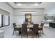 Bright dining room featuring a modern chandelier, a set dining table, and an open view to the kitchen at 18026 Reynolds Pkwy, Orlando, FL 32833