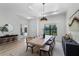 Bright dining room features a modern chandelier and a dining table with seating for six at 18026 Reynolds Pkwy, Orlando, FL 32833