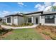 Charming home featuring dark trim windows, a well-manicured lawn, and sidewalk at 18026 Reynolds Pkwy, Orlando, FL 32833