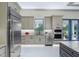 Bright kitchen with stainless steel appliances, custom cabinetry, and marble countertops at 18026 Reynolds Pkwy, Orlando, FL 32833