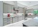 Bright kitchen with stainless steel appliances, custom cabinetry, and marble countertops at 18026 Reynolds Pkwy, Orlando, FL 32833
