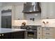 Well-appointed kitchen featuring stainless steel appliances, a pot filler, custom cabinets, and modern lighting at 18026 Reynolds Pkwy, Orlando, FL 32833