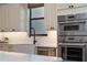 Bright kitchen area boasts a farmhouse sink, stainless steel appliances, and stylish cabinetry, and built in appliances at 18026 Reynolds Pkwy, Orlando, FL 32833