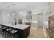 Modern kitchen with a large island, stainless steel appliances, stylish pendant lighting, and beautiful wood flooring at 18026 Reynolds Pkwy, Orlando, FL 32833