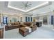 Spacious open-concept living area featuring a brown leather sectional, gourmet kitchen, and bright dining area at 18026 Reynolds Pkwy, Orlando, FL 32833