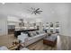 Spacious living room with white sectional, wood flooring, and open view to the kitchen at 18026 Reynolds Pkwy, Orlando, FL 32833