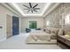 Spacious main bedroom with a stylish tray ceiling, fan, and ensuite bathroom at 18026 Reynolds Pkwy, Orlando, FL 32833