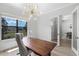 Bright office featuring a modern chandelier, a large desk and view of the backyard at 18026 Reynolds Pkwy, Orlando, FL 32833