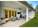 Covered patio with comfortable seating, ceiling fan, and outdoor dining area at 18026 Reynolds Pkwy, Orlando, FL 32833