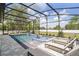 Inviting screened pool with a spa and multiple lounge chairs for relaxing on the patio at 18026 Reynolds Pkwy, Orlando, FL 32833
