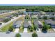 Aerial view of a residential neighborhood featuring lush landscaping and a tranquil pond at 1918 Marabou Dr, Davenport, FL 33896