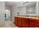 Bathroom featuring double sinks, tile floor, and a glass-enclosed shower at 1918 Marabou Dr, Davenport, FL 33896