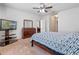 This bedroom features a ceiling fan, dresser, TV, and ample natural light from windows at 1918 Marabou Dr, Davenport, FL 33896