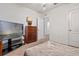 Comfortable bedroom with television, dresser, and neutral carpet at 1918 Marabou Dr, Davenport, FL 33896