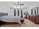 Spacious bedroom featuring a ceiling fan, dresser, TV, and ample natural light from windows at 1918 Marabou Dr, Davenport, FL 33896