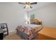 Cozy bedroom featuring a ceiling fan, natural light, and neutral-toned decor at 1918 Marabou Dr, Davenport, FL 33896