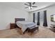 Cozy bedroom with a ceiling fan, dresser, TV, and ample natural light from windows at 1918 Marabou Dr, Davenport, FL 33896