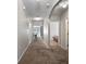 The home features a long hallway with neutral walls and carpet, and arched entryways at 1918 Marabou Dr, Davenport, FL 33896