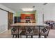 Bright kitchen with stainless steel appliances, breakfast bar, and a rustic wood accent sliding barn door at 1918 Marabou Dr, Davenport, FL 33896