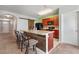 Spacious kitchen featuring a breakfast bar, black appliances, and a sliding barn door at 1918 Marabou Dr, Davenport, FL 33896