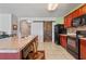 Well-lit kitchen features a breakfast bar, tile flooring, and stainless steel appliances at 1918 Marabou Dr, Davenport, FL 33896
