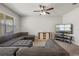 The living room features an oversized sectional sofa, ceiling fan, and a large window at 1918 Marabou Dr, Davenport, FL 33896