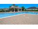 Community pool with brick surround, bath house and lounge chairs for relaxing on hot days at 1918 Marabou Dr, Davenport, FL 33896