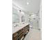 Modern bathroom featuring double sinks, a sleek shower with glass door, and updated fixtures at 2131 Nicollett Way, Leesburg, FL 34748