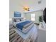 Serene bedroom with a gray upholstered bed, blue bedding, modern accents, and a calming ambiance at 2131 Nicollett Way, Leesburg, FL 34748