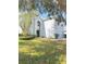 Charming two-story home with a manicured lawn, mature trees, and a light blue and white exterior paint scheme at 2131 Nicollett Way, Leesburg, FL 34748