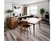 Bright, modern office space with wood floors, a large desk, and a minimalist aesthetic at 2131 Nicollett Way, Leesburg, FL 34748