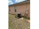 Exterior side view of the home with an air conditioning unit at 220 Abbotsbury Dr, Kissimmee, FL 34758
