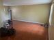 Open concept living room with decorative flooring and a chandelier at 220 Abbotsbury Dr, Kissimmee, FL 34758