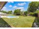A backyard featuring a pool with patio area surrounded by grass and privacy fence at 2311 Huron Trl, Maitland, FL 32751