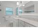 A bathroom featuring marble countertop, white cabinets, and vanity mirror at 2311 Huron Trl, Maitland, FL 32751