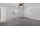 A bright bedroom featuring a ceiling fan and two windows which provide natural light at 2311 Huron Trl, Maitland, FL 32751