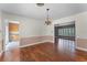 Bright dining room featuring hardwood floors, classic chandelier and wainscoting detail at 2311 Huron Trl, Maitland, FL 32751