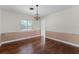 Bright dining room with large window, chandelier, and hardwood flooring at 2311 Huron Trl, Maitland, FL 32751