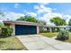 Well-maintained home with a spacious driveway and lush front lawn at 2311 Huron Trl, Maitland, FL 32751