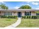 Charming home featuring a well-manicured front yard and a welcoming front door at 2311 Huron Trl, Maitland, FL 32751