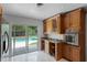 Bright kitchen featuring a breakfast bar and sliding glass doors leading to the outdoor pool area at 2311 Huron Trl, Maitland, FL 32751